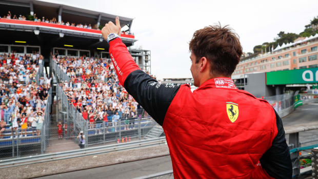 Ferrari F1 driver Charles Leclerc gives a thumbs-up to the crowd in Monaco after qualifying on pole.
