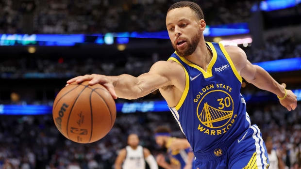 Golden State Warriors guard Stephen Curry (30) reaches for the ball against the Dallas Mavericks during the first quarter in game four of the 2022 Western Conference finals at American Airlines Center.