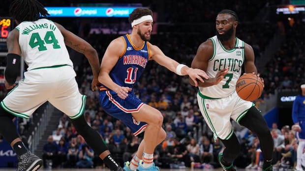 Mar 16, 2022; San Francisco, California, USA; Boston Celtics guard Jaylen Brown (7) dribbles the ball next to Golden State Warriors guard Klay Thompson (11) in the third quarter at the Chase Center.