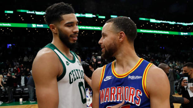 Dec 17, 2021; Boston, Massachusetts, USA; Boston Celtics forward Jayson Tatum (0) talks with Golden State Warriors guard Stephen Curry (30) after their game at TD Garden.