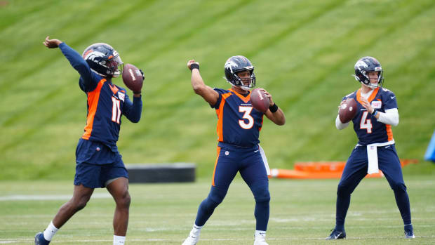 Denver Broncos quarterback Josh Johnson (11) and quarterback Russel Wilson (3) and quarterback Brett Rypien (4) during OTA workouts at the UC Health Training Center.