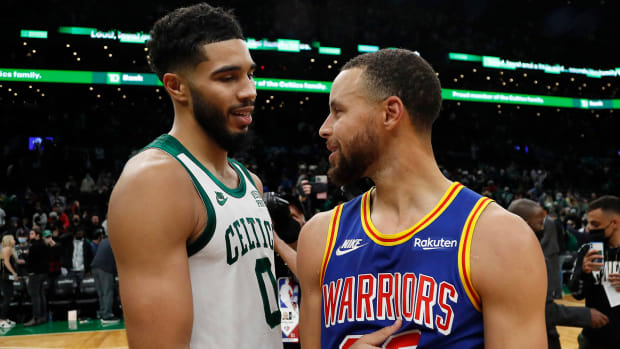 Boston Celtics forward Jayson Tatum (left) talks with Golden State Warriors guard Stephen Curry.