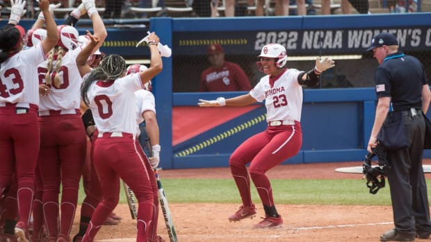 Jun 2, 2022; Oklahoma City, Oklahoma, USA; Oklahoma Sooners 2b/3b Tiare Jennings (23) celebrates with teammates at home plate after hitting a grand slam during the third inning of the NCAA Women’s College World Series game against the Northwestern Wildcats at USA Softball Hall of Fame Stadium. Mandatory Credit: Brett Rojo-USA TODAY Sports