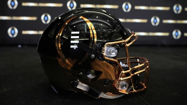 The College Football Playoff logo on a helmet.