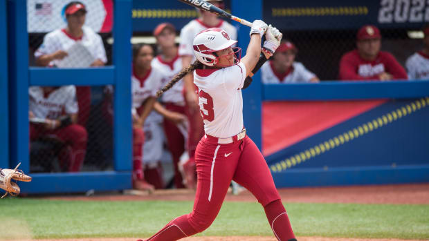 Jun 2, 2022; Oklahoma City, Oklahoma, USA; Oklahoma Sooners 2b/3b Tiare Jennings (23) watches the ball after hitting a grand slam during the third inning of the NCAA Women's College World Series game against the Northwestern Wildcats at USA Softball Hall of Fame Stadium.