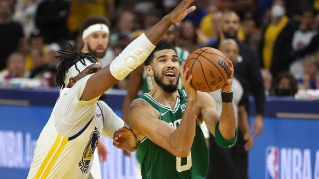 Boston Celtics forward Jayson Tatum (0) drives to the basket against Golden State Warriors center Kevon Looney during the second half of Game 1 of basketball’s NBA Finals in San Francisco, Thursday, June 2, 2022.