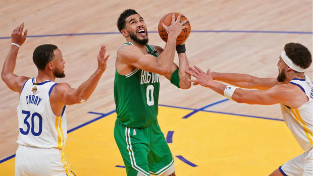 Jun 2, 2022; San Francisco, California, USA; Boston Celtics forward Jayson Tatum (0) controls the ball while defended by Golden State Warriors guard Stephen Curry (30) and guard Klay Thompson (right) during the second half of game one of the 2022 NBA Finals at Chase Center. Mandatory Credit: Cary Edmondson-USA TODAY Sports