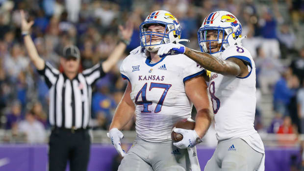 Nov 20, 2021; Fort Worth, Texas, USA; Kansas Jayhawks fullback Jared Casey (47) celebrates his touchdown catch with wide receiver Kwamie Lassiter II (8) against the TCU Horned Frogs during the second half at Amon G. Carter Stadium.