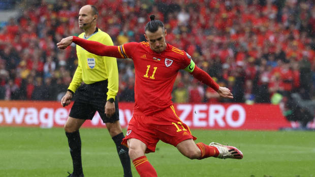 Gareth Bale pictured taking a free-kick for Wales that resulted in an own goal scored by Ukraine's Andriy Yarmolenko in the FIFA World Cup qualifying play-off in June 2022