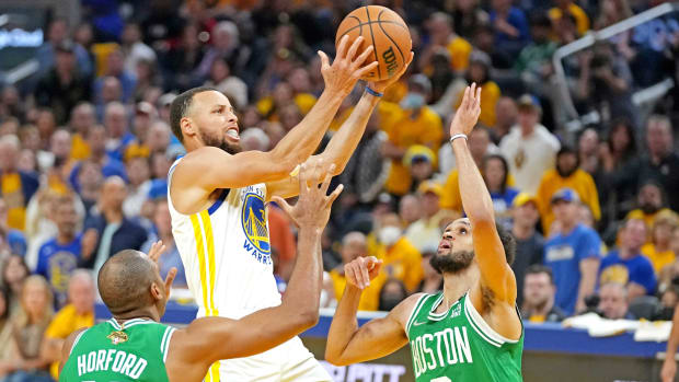 Warriors guard Stephen Curry (30) shoots the ball against Celtics guard Derrick White (9) during Game 2 of the 2022 NBA Finals.