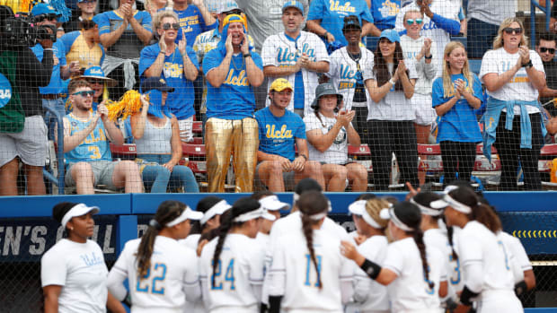 UCLA fans cheer on their team against Texas during the first inning of an NCAA softball Women’s College World Series game on Thursday, June 2, 2022, in Oklahoma City. (AP Photo/Alonzo Adams)