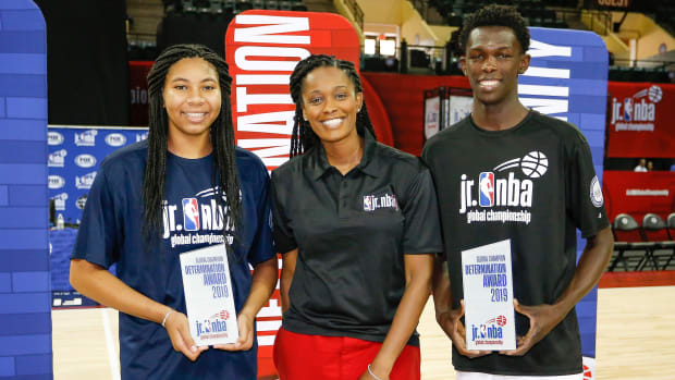 WNBA star Swin Cash poses with Determination Award winners Marouf Moumine (right) and Breya Cunningham (left) during the closing ceremonies of the Jr. NBA Championship Tournament at ESPN Wide World of...