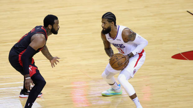 Apr 23, 2021; Houston, Texas, USA; Paul George #13 of the Los Angeles Clippers dribbles against John Wall #1 of the Houston Rockets during the first quarter at Toyota Center. Mandatory Credit: Carmen Mandato/POOL PHOTOS-USA TODAY Sports