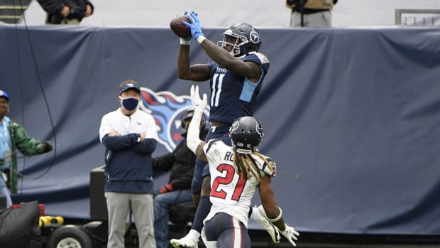 Tennessee Titans wide receiver A.J. Brown (11) scores a touchdown over Houston Texans cornerback Bradley Roby (21) with four seconds left to tie the game during second half at Nissan Stadium.