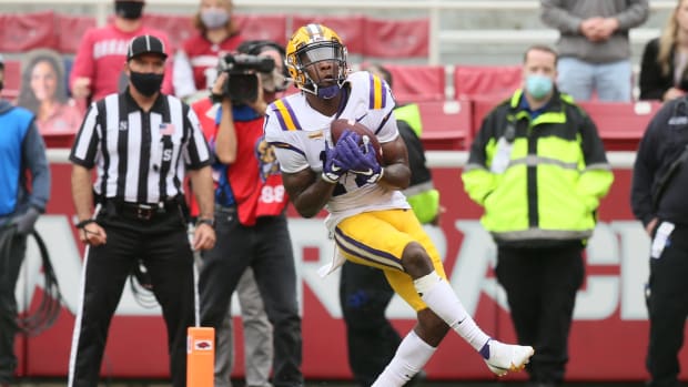 LSU Tigers wide receiver Racey McMath (17) catches a pass for a touchdown in the second quarter against the Arkansas Razorbacks at Donald W. Reynolds Razorback Stadium.