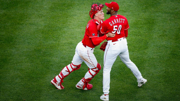 Cincinnati Reds catcher Tyler Stephenson (37) holds back Cincinnati Reds relief pitcher Amir Garrett (50) as the benches clear in the eighth inning of the baseball game against the Chicago Cubs, Saturday, May 1, 2021, at Great American Ball Park in Cincinnati.
