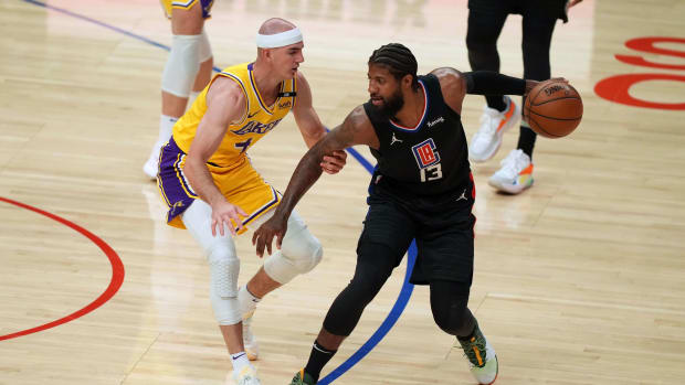 May 6, 2021; Los Angeles, California, USA; LA Clippers guard Paul George (13) handles the ball while defended by Los Angeles Lakers guard Alex Caruso (4) in the first half at Staples Center. Mandatory Credit: Kirby Lee-USA TODAY Sports