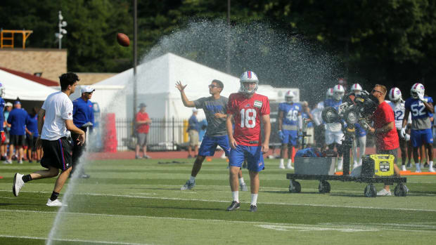 Automatic sprinklers turned on one section of the field during the first day of training camp at St. John Fisher College.