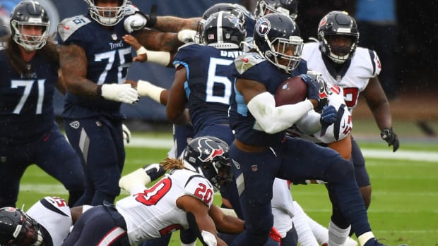 Tennessee Titans running back Derrick Henry (22) runs for a first down during the first half against the Houston Texans at Nissan Stadium.