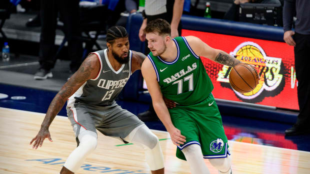 Mar 17, 2021; Dallas, Texas, USA; LA Clippers guard Paul George (13) and Dallas Mavericks guard Luka Doncic (77) in action during the game between the Dallas Mavericks and the LA Clippers at the American Airlines Center. Mandatory Credit: Jerome Miron-USA TODAY Sports