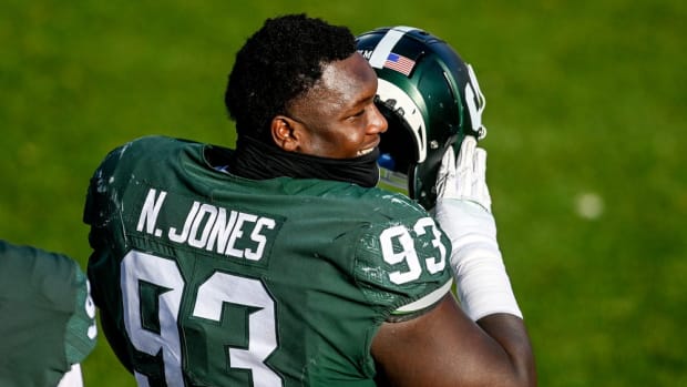Michigan State's Naquan Jones talks with teammates on the sideline during the third quarter in the game against Indiana on Saturday, Nov. 14, 2020, at Spartan Stadium in East Lansing.