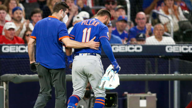 May 17, 2021; Atlanta, Georgia, USA; New York Mets center fielder Kevin Pillar (11) is helped off the field after being hit by a pitch against the Atlanta Braves in the seventh inning at Truist Park.