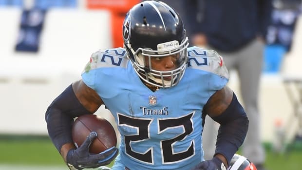 Tennessee Titans running back Derrick Henry (22) gets away from a tackle attempt from Cleveland Browns defensive tackle Larry Ogunjobi (65) at Nissan Stadium.