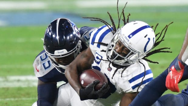 Tennessee Titans linebacker Jayon Brown (55) brings down Indianapolis Colts wide receiver T.Y. Hilton (13) during the second quarter at Nissan Stadium Thursday, Nov. 12, 2020 in Nashville, Tenn.