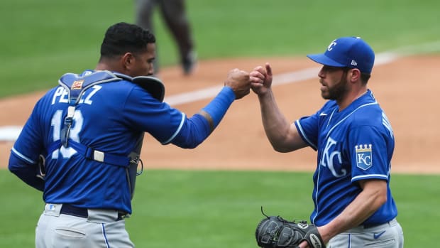 May 30, 2021; Minneapolis, Minnesota, USA; Kansas City Royals catcher Salvador Perez (13) and relief pitcher Greg Holland (35) celebrate their victory against the Minnesota Twins at Target Field. Mandatory Credit: David Berding-USA TODAY Sports