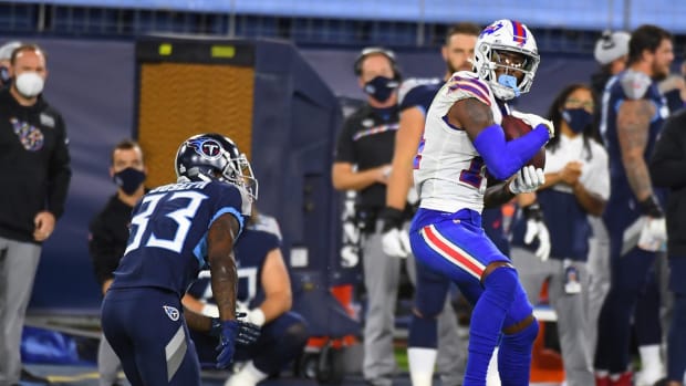 Buffalo Bills wide receiver Stefon Diggs (14) catches a pass in front of coverage from Tennessee Titans cornerback Johnathan Joseph (33) during the first half at Nissan Stadium.