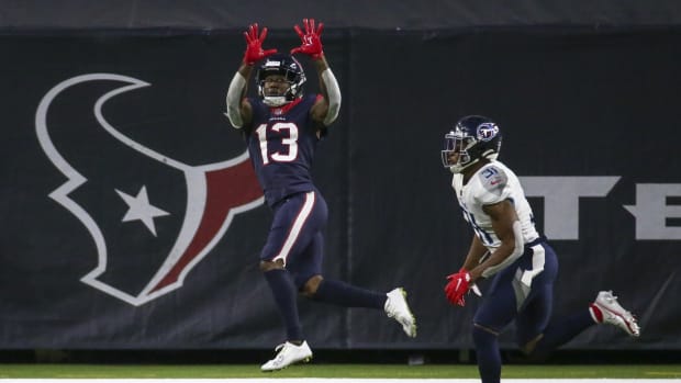 Houston Texans wide receiver Brandin Cooks (13) makes a reception for a touchdown as Tennessee Titans free safety Kevin Byard (31) defends during the third quarter at NRG Stadium.