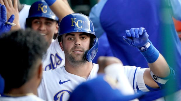 Jun 4, 2021; Kansas City, Missouri, USA; Kansas City Royals second baseman Whit Merrifield (15) is congratulated in the dugout after hitting a two run home run in the first inning against the Minnesota Twins at Kauffman Stadium. Mandatory Credit: Denny Medley-USA TODAY Sports