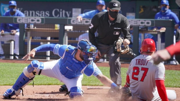 Apr 14, 2021; Kansas City, Missouri, USA; Kansas City Royals catcher Cam Gallagher (36) misses the ball and the tag on Los Angeles Angels center fielder Mike Trout (27) at the plate in the sixth inning at Kauffman Stadium. Mandatory Credit: Denny Medley-USA TODAY Sports