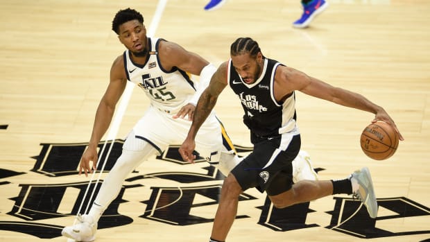 Jun 12, 2021; Los Angeles, California, USA; LA Clippers forward Kawhi Leonard (2) moves the ball while Utah Jazz guard Donovan Mitchell (45) defends in the third quarter during game three in the second round of the 2021 NBA Playoffs. at Staples Center. Mandatory Credit: Kelvin Kuo-USA TODAY Sports