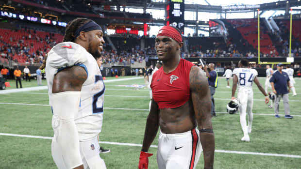 Tennessee Titans running back Derrick Henry (22) talks with Atlanta Falcons wide receiver Julio Jones (11) after their game at Mercedes-Benz Stadium.