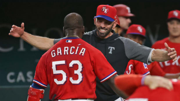 May 21, 2021; Arlington, Texas, USA; Texas Rangers center fielder Adolis Garcia (53) celebrates with manager Chris Woodward (8) after hitting a walk-off three run home run during the tenth inning to defeat the Houston Astros at Globe Life Field.