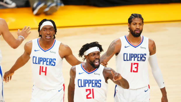 Jun 22, 2021; Phoenix, Arizona, USA; Los Angeles Clippers guard Patrick Beverley (21) celebrates with Paul George (13) and Terance Mann (14) against the Phoenix Suns in the second half during game two of the Western Conference Finals for the 2021 NBA Playoffs at Phoenix Suns Arena. Mandatory Credit: Mark J. Rebilas-USA TODAY Sports