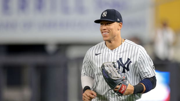 Aaron Judge smiling while running on defense