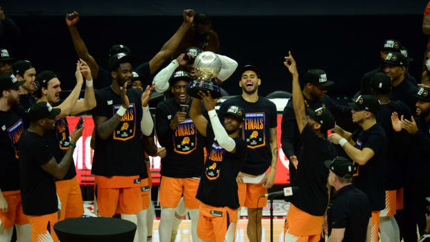 Jun 30, 2021; Los Angeles, California, USA; Phoenix Suns guard Chris Paul (3) lifts the Western Conference champions trophy following the series victory against the Los Angeles Clippers in game six of the Western Conference Finals for the 2021 NBA Playoffs at Staples Center. Mandatory Credit: Gary A. Vasquez-USA TODAY Sports