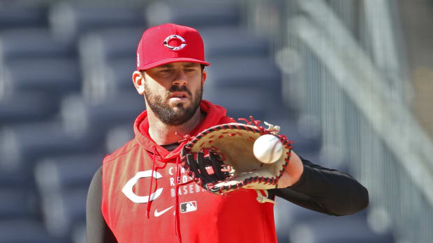 May 10, 2021; Pittsburgh, Pennsylvania, USA; Cincinnati Reds first baseman Mike Moustakas (9) plays catch on the field before the game against the Pittsburgh Pirates at PNC Park. Mandatory Credit: Charles LeClaire-USA TODAY Sports
