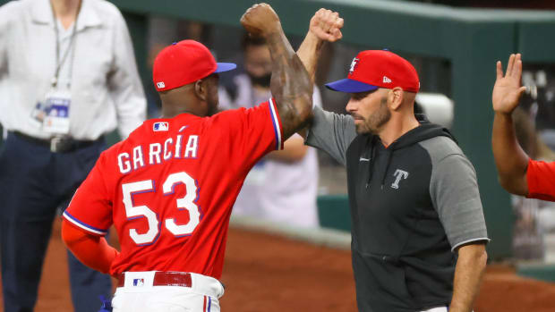 Jul 9, 2021; Arlington, Texas, USA; Texas Rangers center fielder Adolis Garcia and manager Chris Woodward (8) celebrate the win against the Oakland Athletics at Globe Life Field.