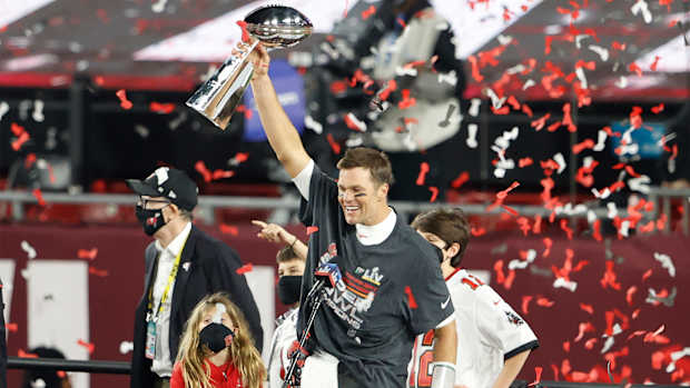 Feb 7, 2020; Tampa, FL, USA; Tampa Bay Buccaneers quarterback Tom Brady (12) lifts the Lombardi Trophy after Super Bowl LV at Raymond James Stadium.