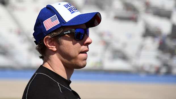 Jun 20, 2021; Nashville, Tennessee, USA; NASCAR Cup Series driver Brad Keselowski (2) waits beside his car before qualifying for the Ally 400 at Nashville Superspeedway.