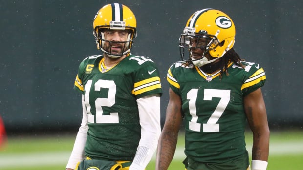 Aaron Rodgers and Davante Adams talk as they walk off the field during a 2020 game