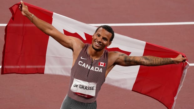 Andre De Grasse celebrates winning the Olympic gold medal in the men's 200 meters.