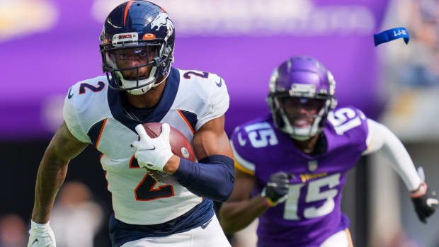 Denver Broncos cornerback Pat Surtain II (2) intercepts the ball for a touchdown against the Minnesota Vikings in the second quarter at U.S. Bank Stadium.