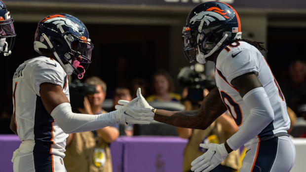 Denver Broncos wide receiver K.J. Hamler (1) and wide receiver Jerry Jeudy (right) react after a touchdown reception by Hamler against the Minnesota Vikings during the first quarter at U.S. Bank Stadium.