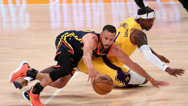 May 19, 2021; Los Angeles, California, USA; Los Angeles Lakers guard Kentavious Caldwell-Pope (1) and Golden State Warriors guard Stephen Curry (30) scramble for a loose ball in the fourth quarter of the game at Staples Center. Mandatory Credit: Jayne Kamin-Oncea-USA TODAY Sports