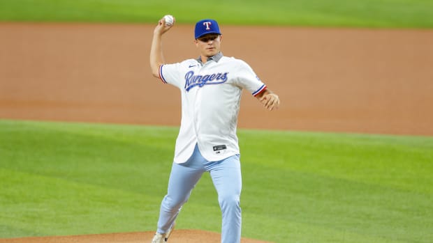 Jul 28, 2021; Arlington, Texas, USA; Texas Rangers number one draft choice pitcher Jack Leiter throws out the ceremonial first pitch prior to the game against the Arizona Diamondbacks at Globe Life Field.