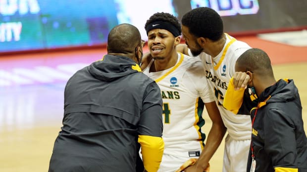Mar 18, 2021; Bloomington, Indiana, USA; Norfolk State Spartans guard Devante Carter (center) reacts after their win over the Appalachian State Mountaineers with head coach Robert Jones and forward J.J. Matthews (right) in the First Four of the 2021 NCAA Tournament at Simon Skjodt Assembly Hall. The Norfolk State Spartans won 54-53. Mandatory Credit: Trevor Ruszkowski-USA TODAY Sports